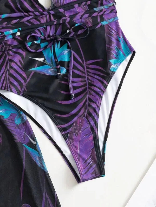 Women's patterned three-piece swimsuit set with bikini and cover-up coat on a mannequin.
