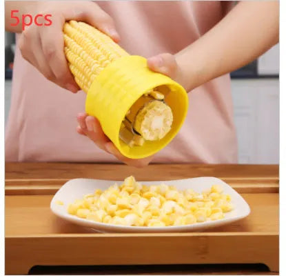 Yellow manual corn grinder thresher with corn-shaped design and stainless steel peeling gear.