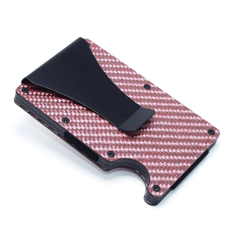 Slim black carbon fibre card holder wallet with geometric design on a desk.