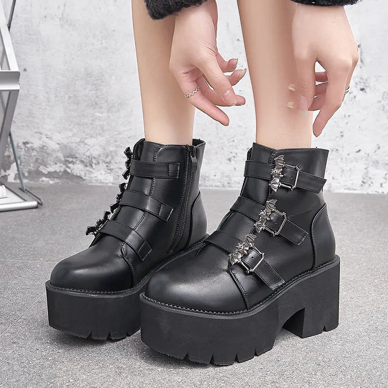 Black women's punk gothic short ankle boots with a bat buckle and side zip.