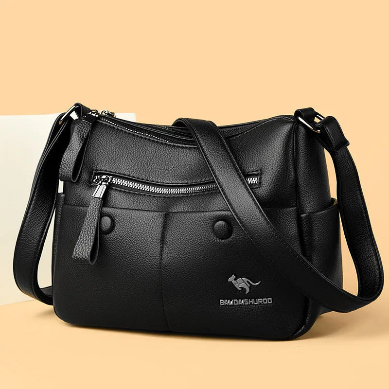 Soft square black PU leather women's crossbody shoulder bag showing front view and open interior with multiple pockets.