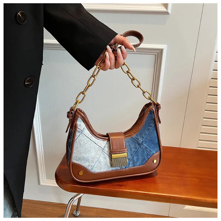 Brown denim women's bucket shoulder bag with diamond mesh detail and chain strap connector.