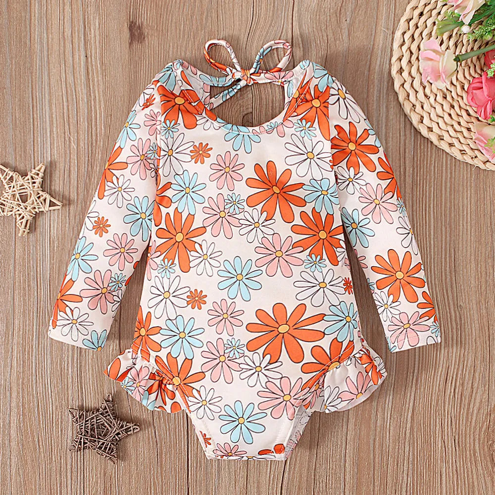 Girl's floral pattern swimsuit with crew neck and open back design in polyester fabric