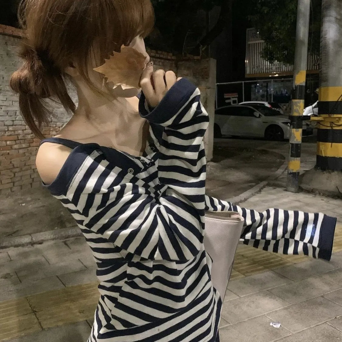 Dark blue Korean-style oversized women's long-sleeved t-shirt with stripes, buttons, and embroidery detail.