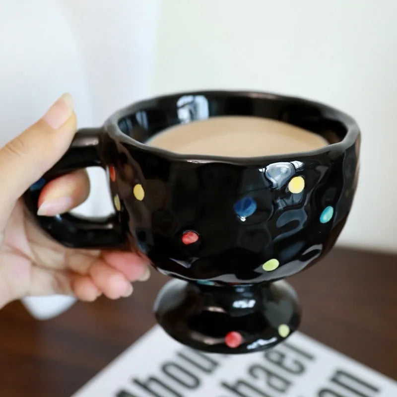 Hand-pinched irregular ceramic mug in a solid colour, showing its unique shape.