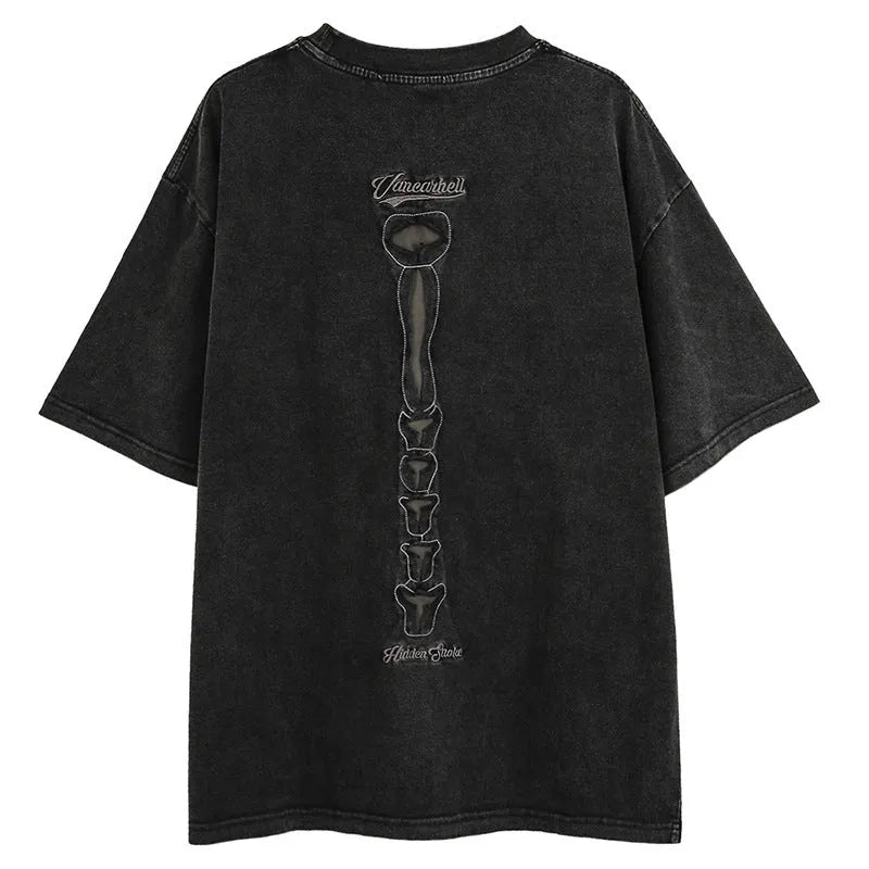Man modelling a black loose-fit cotton short sleeve top with a white skull and letter graphic print.