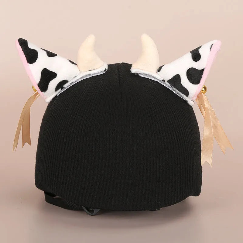 Soft plush cartoon character cover on a motorcycle helmet, showing size M and decorative ear sections.