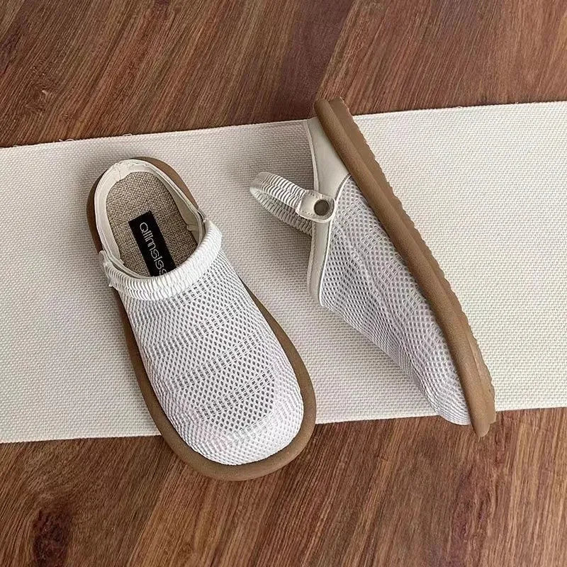 Milky white linen slip-on hole shoes with mesh lining and a light brown rubber sole, shown from the side.