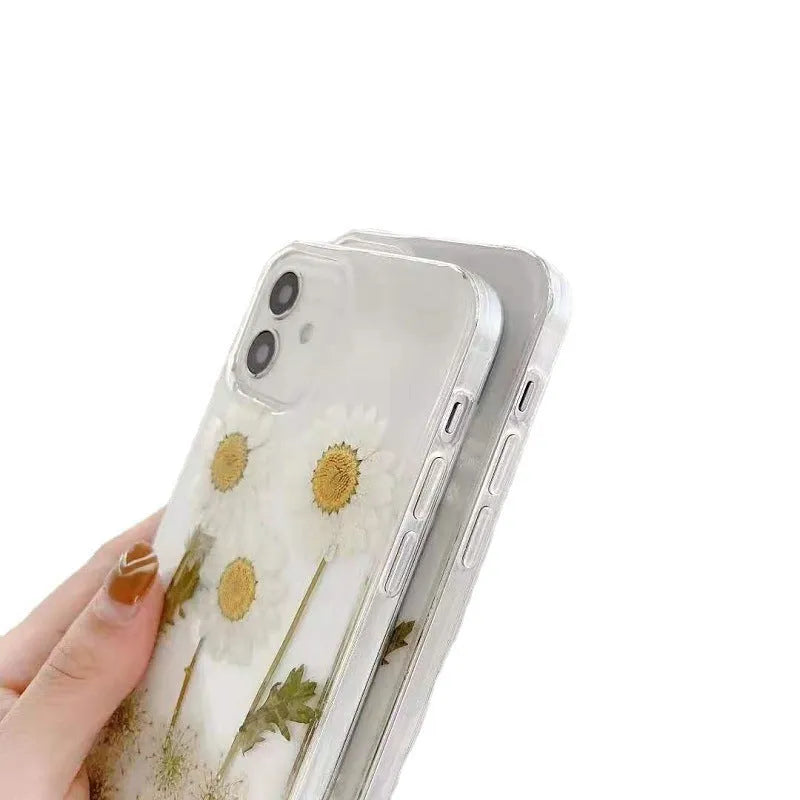 White epoxy daisy floral pattern on a glass back iPhone protective case.
