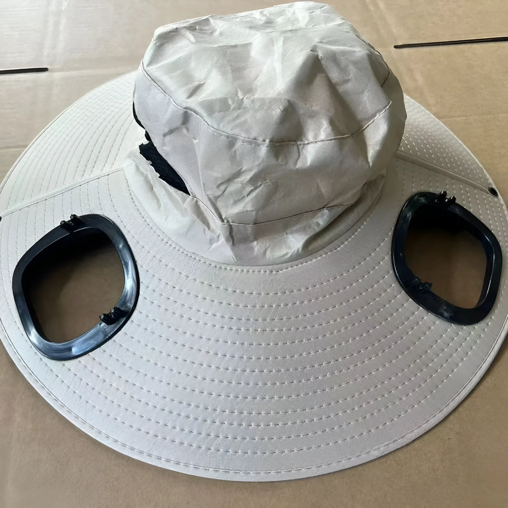 Men's grey sun shading cap with large eave and integrated solar fan for outdoor cooling