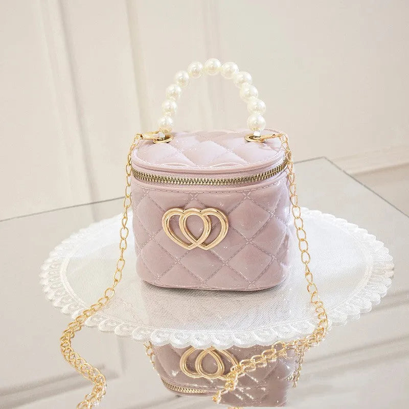 White PVC bucket bag with a red heart pattern, showing its shape and design.