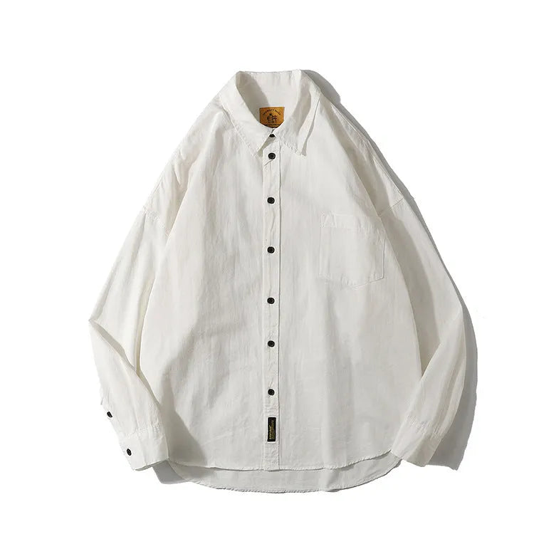 Men's loose-fit cotton cardigan shirt in solid colours on a hanger.
