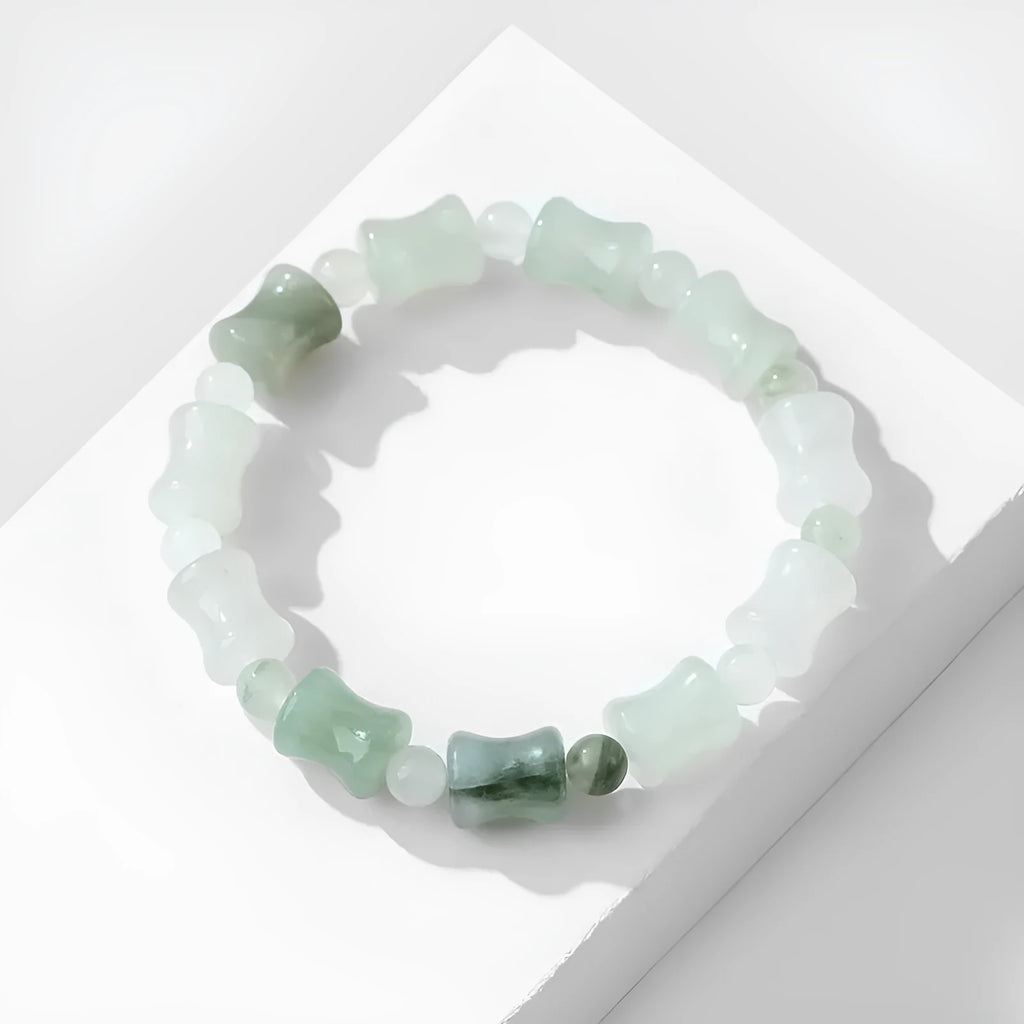 Simple beaded bracelet with chalcedony and coconut shell beads, diamond jade piece, and safety lock.