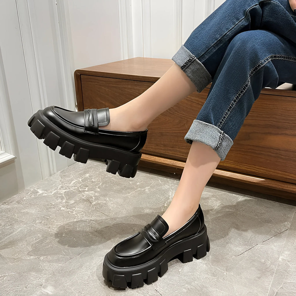 A pair of British style wide fit loafers in patent leather and matte finish options.