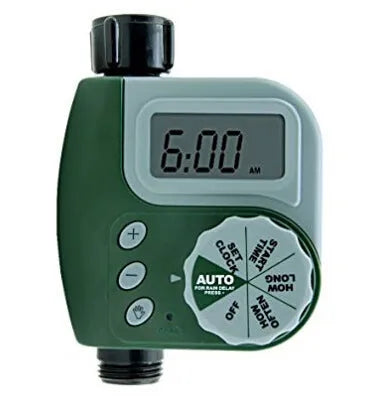 Green programmable digital garden hose timer with dual outlets and large LCD display connected to a faucet.
