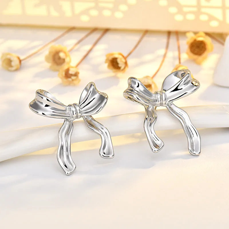 Silver bow earrings for women, copper electroplated, single ear clip and bow ear buckle single, cold wind style