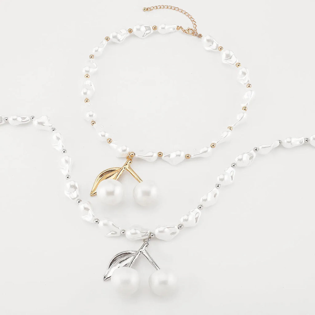 Women's adjustable geometric fruit pendant necklace on a pearl chain in gold or white K.