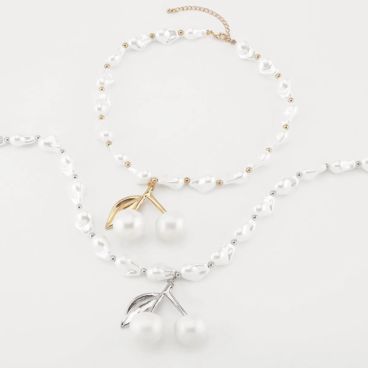 Women's adjustable geometric fruit pendant necklace on a pearl chain in gold or white K.