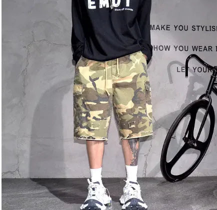 Loose-fit cotton camouflage shorts in retro workwear style on a plain background.