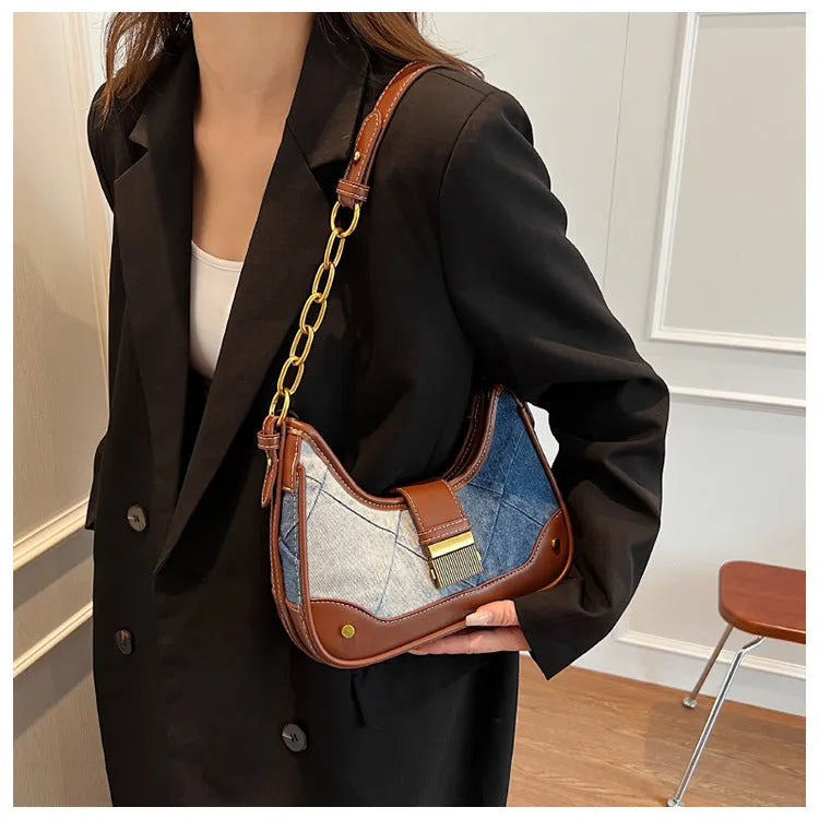 Brown denim women's bucket shoulder bag with diamond mesh detail and chain strap connector.