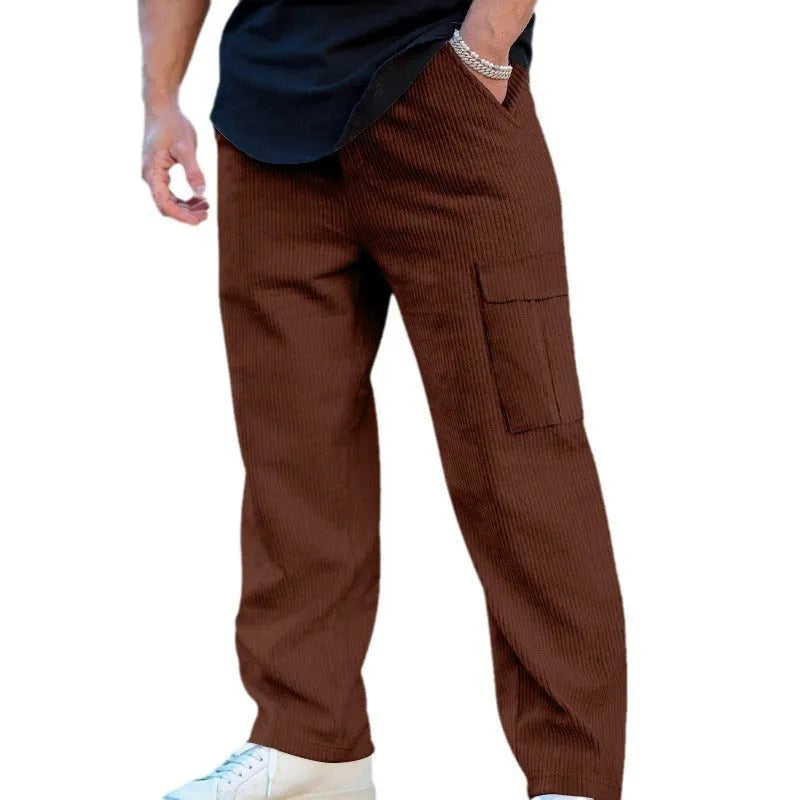 Men's navy blue corduroy cargo trousers with loose fit and straight legs on a hanger.