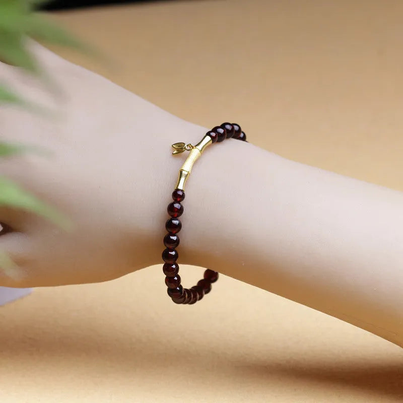 Natural garnet stone set in a 6mm bamboo joint ring bracelet with copper or silver finish.
