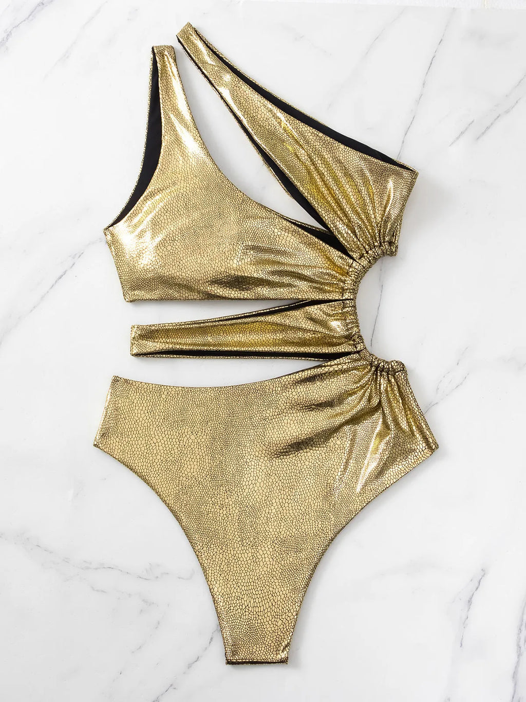Gold backless one-piece swimsuit for women on a neutral background