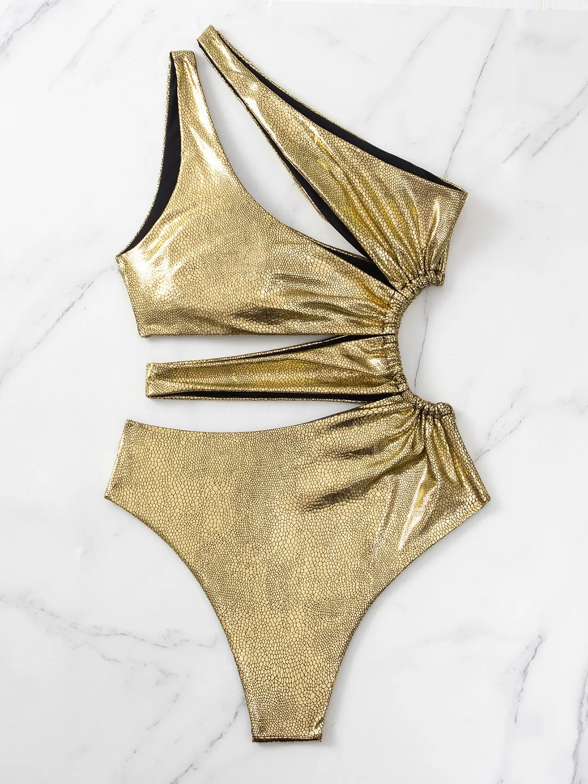 Gold backless one-piece swimsuit for women on a neutral background