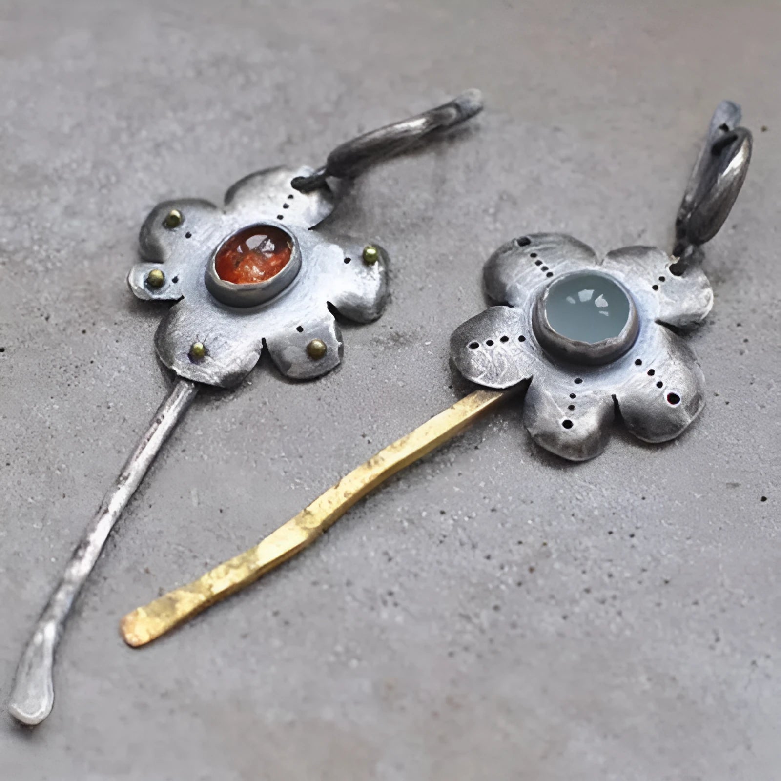 A pair of long retro-style earrings with a geometric floral shape in an asymmetric two-tone colour finish.