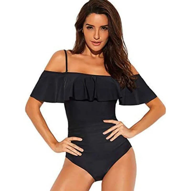 Black women's one-piece swimsuit with side cut-outs and ruffled straps on a tube top.