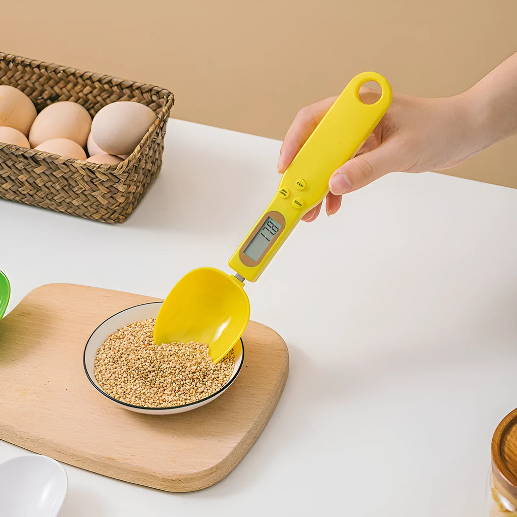 White digital spoon scale with LCD display showing weight measurement for kitchen ingredients