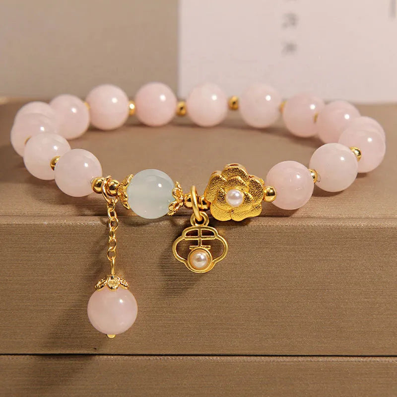 Women's pink crystal flower bracelet with floral pattern design and clasp closure