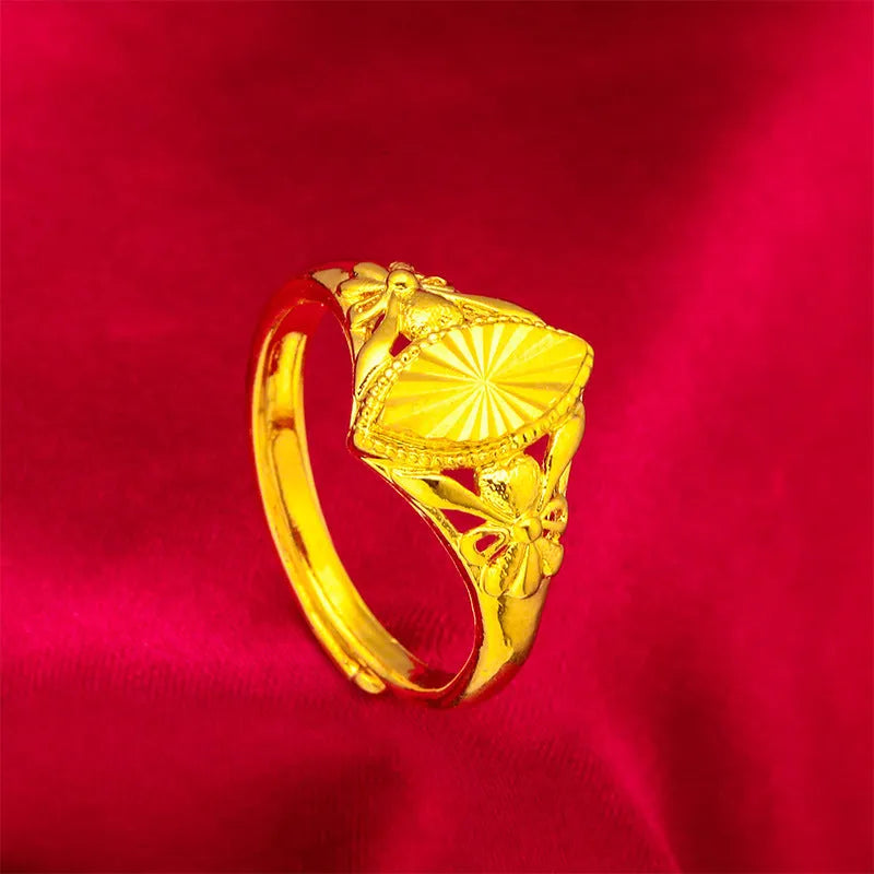 Gold-coloured brass ring with geometric open diamond flower pattern and textured surface