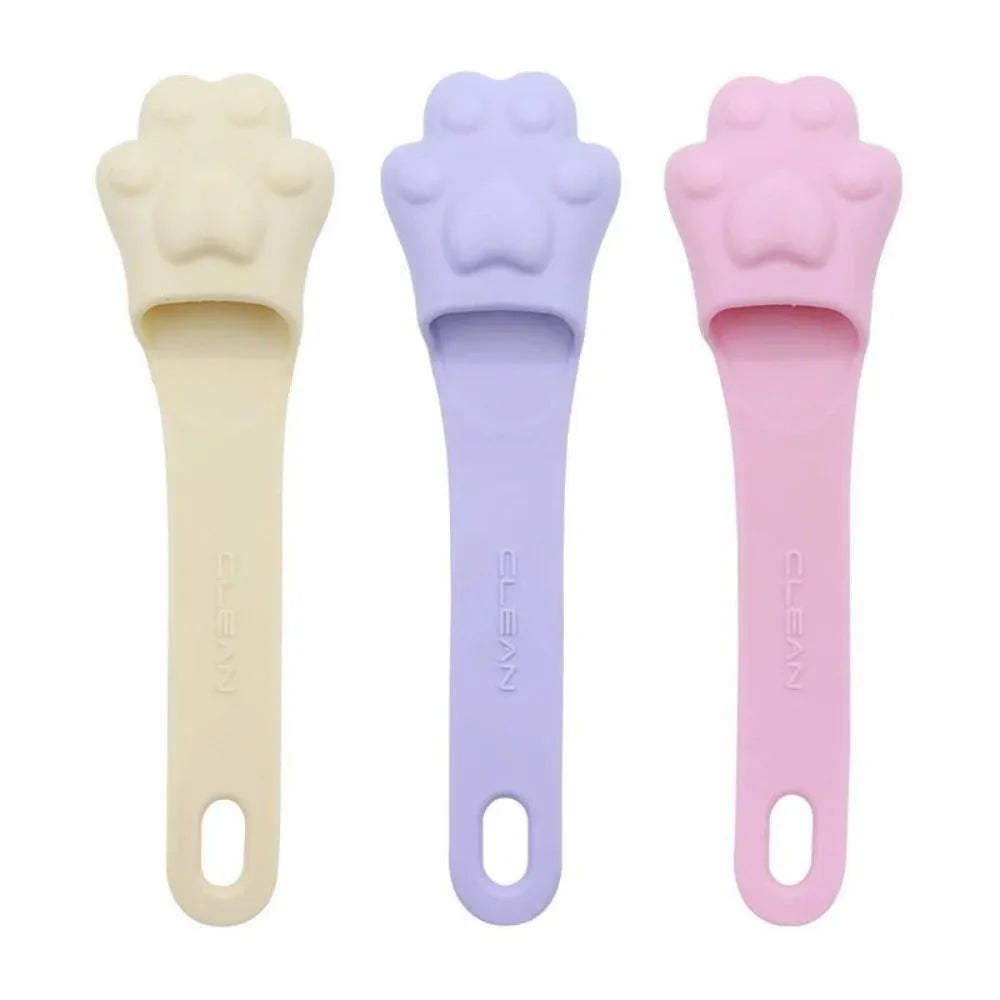 Silicone finger cover toothbrush for dogs and cats in pink, purple, yellow, and white.