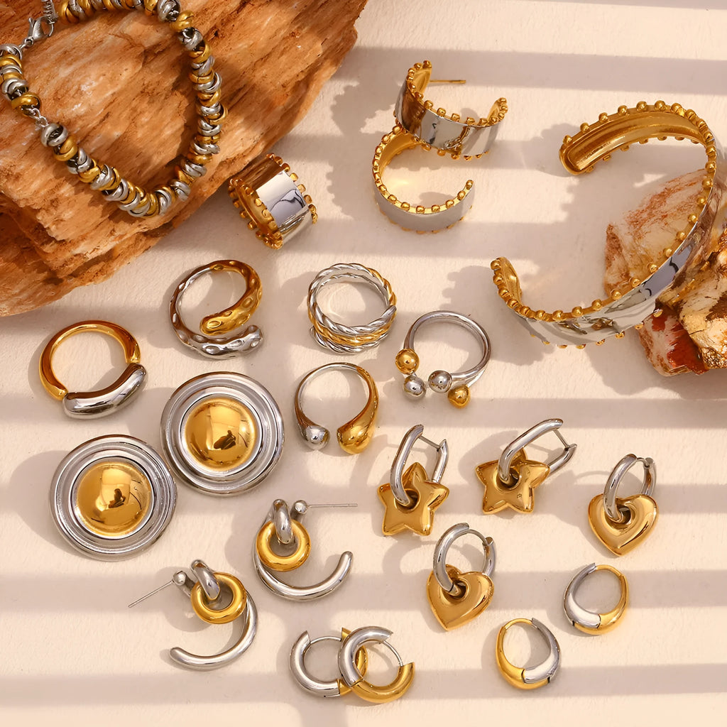 Gold electroplated stainless steel jewellery set with geometric earrings, necklace, and bracelet.