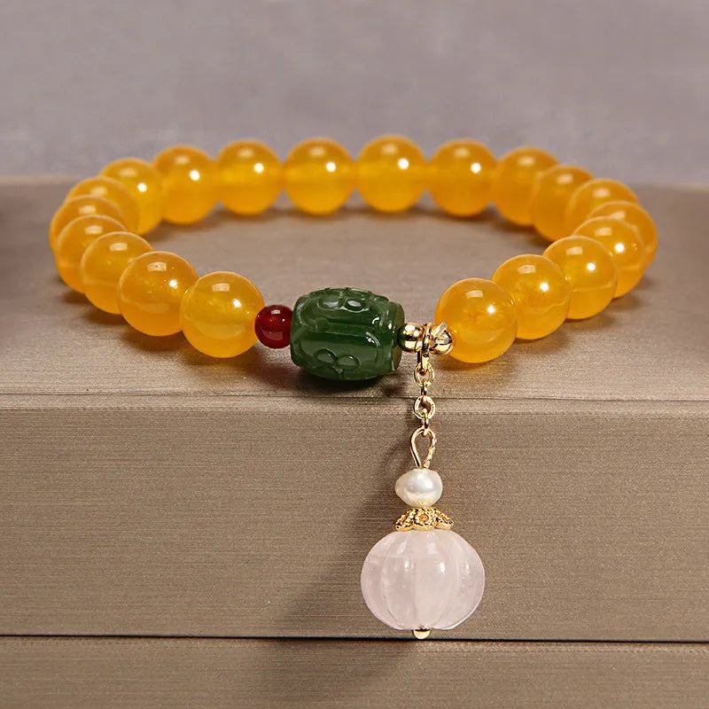 Yellow agate stone bracelet for women with gold silk threading on a wrist