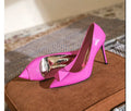 Pink women's patent leather stiletto high heels with a buckle and pointed toe.