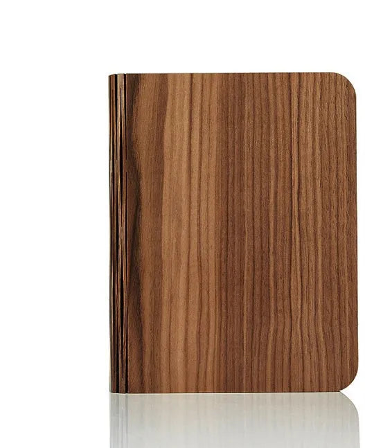 Solid wood book light in three sizes on a desk, showing white and warm white light options.