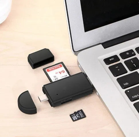 Black smart three-in-one card reader with micro USB and USB 2.0 plugs on a light surface