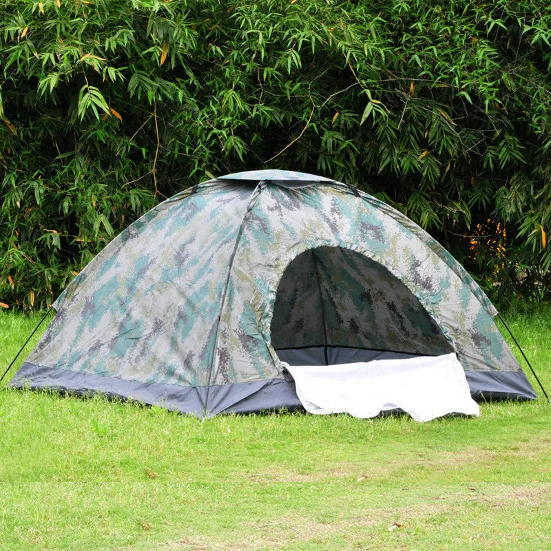 Green camouflage tent with triangular skylight and fibreglass poles set up outdoors