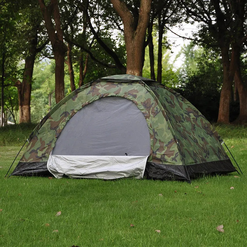 Green camouflage tent with triangular skylight and fibreglass poles set up outdoors