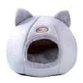 Fully enclosed plush cat winter nest sofa bed with removable cushion, shown in grey