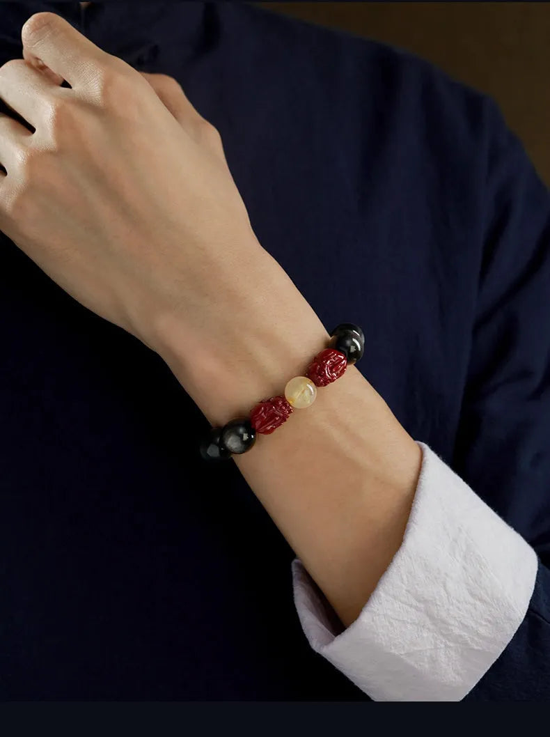 Hand-carved natural cinnabar bead bracelet with Jinniu animal design in gold or silver obsidian.