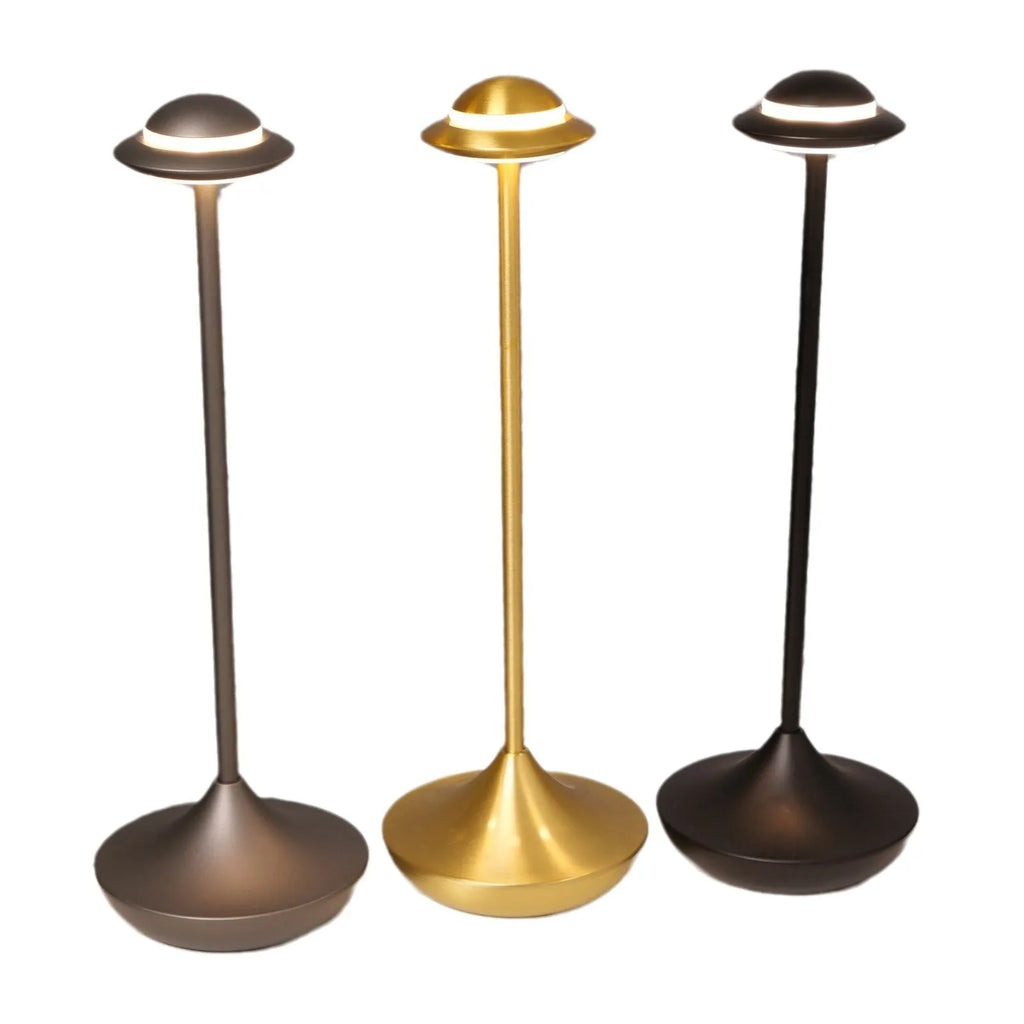 Rechargeable UFO-shaped metal desk lamp in black on a wooden table.