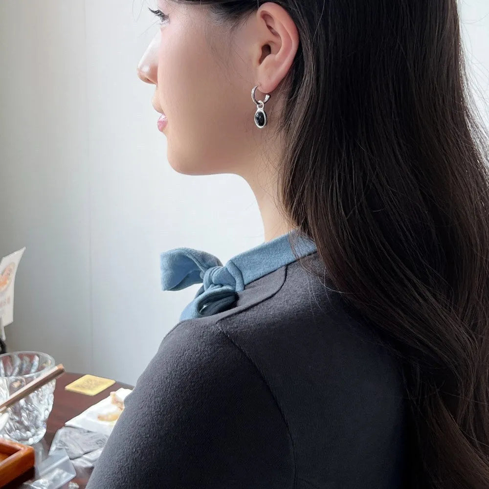 S925 sterling silver stud earrings for women with black agate and a geometric ellipse shape in silver