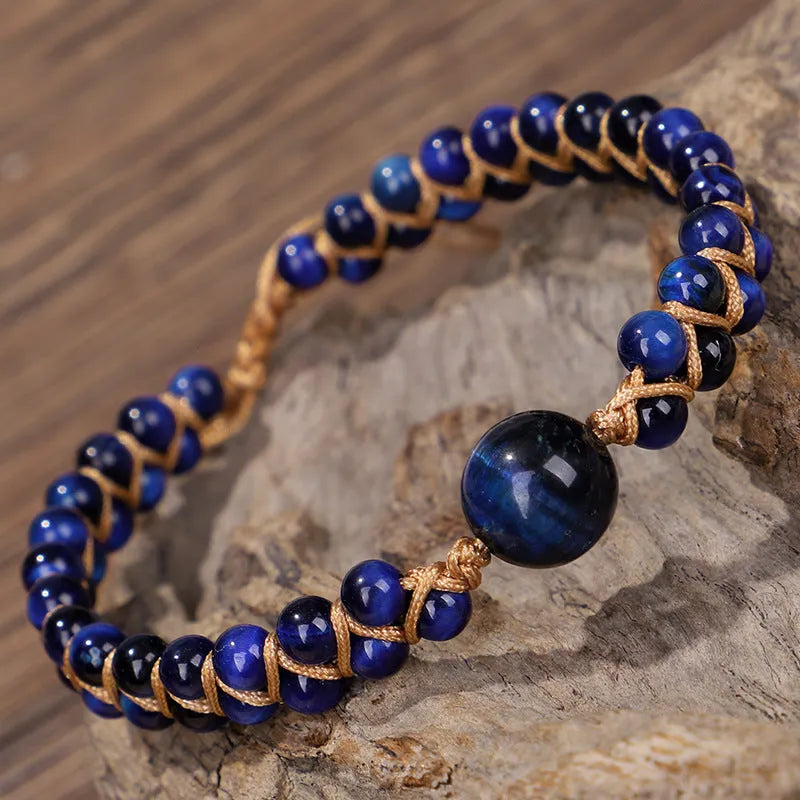 Handwoven geometric bracelet made from blue Tigereye stone beads with a slip-on closure.