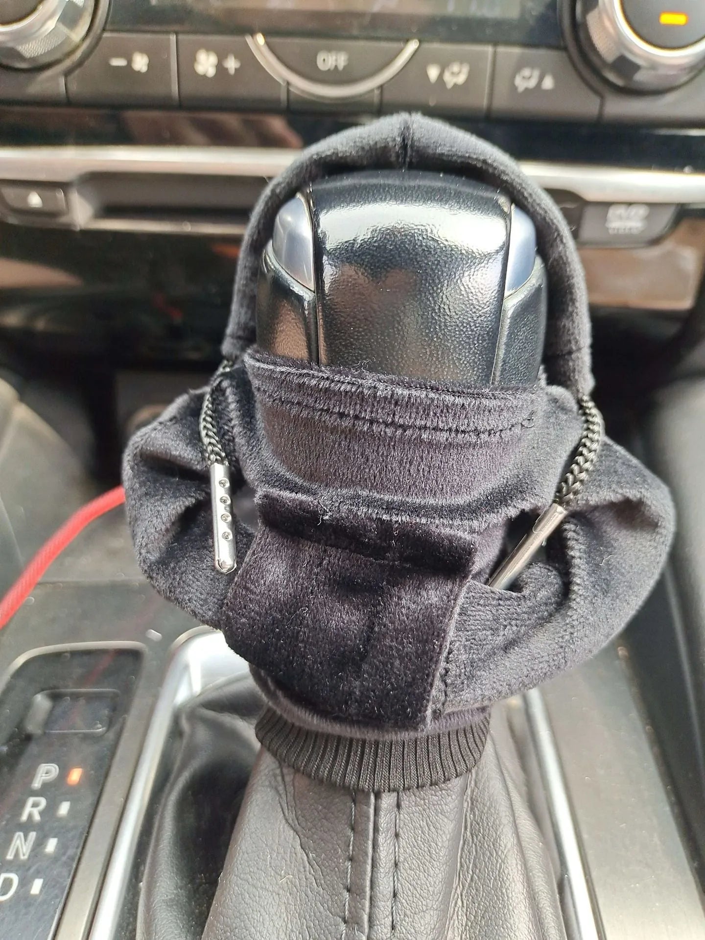 Knitted pure cotton gear lever decoration cover in assorted colours on a car gearstick.