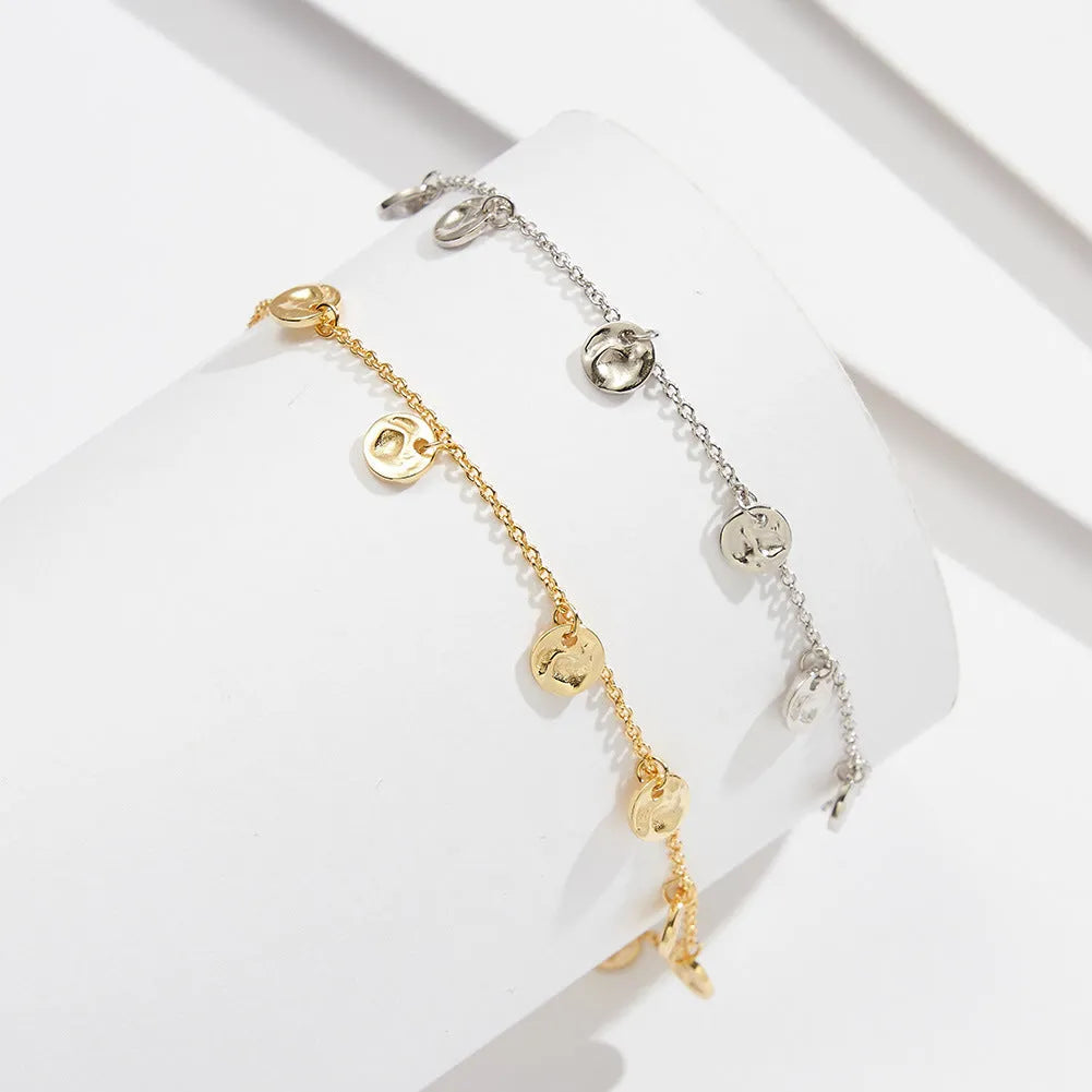 Round silver anklet with geometric han-style pattern in gold or platinum plated options