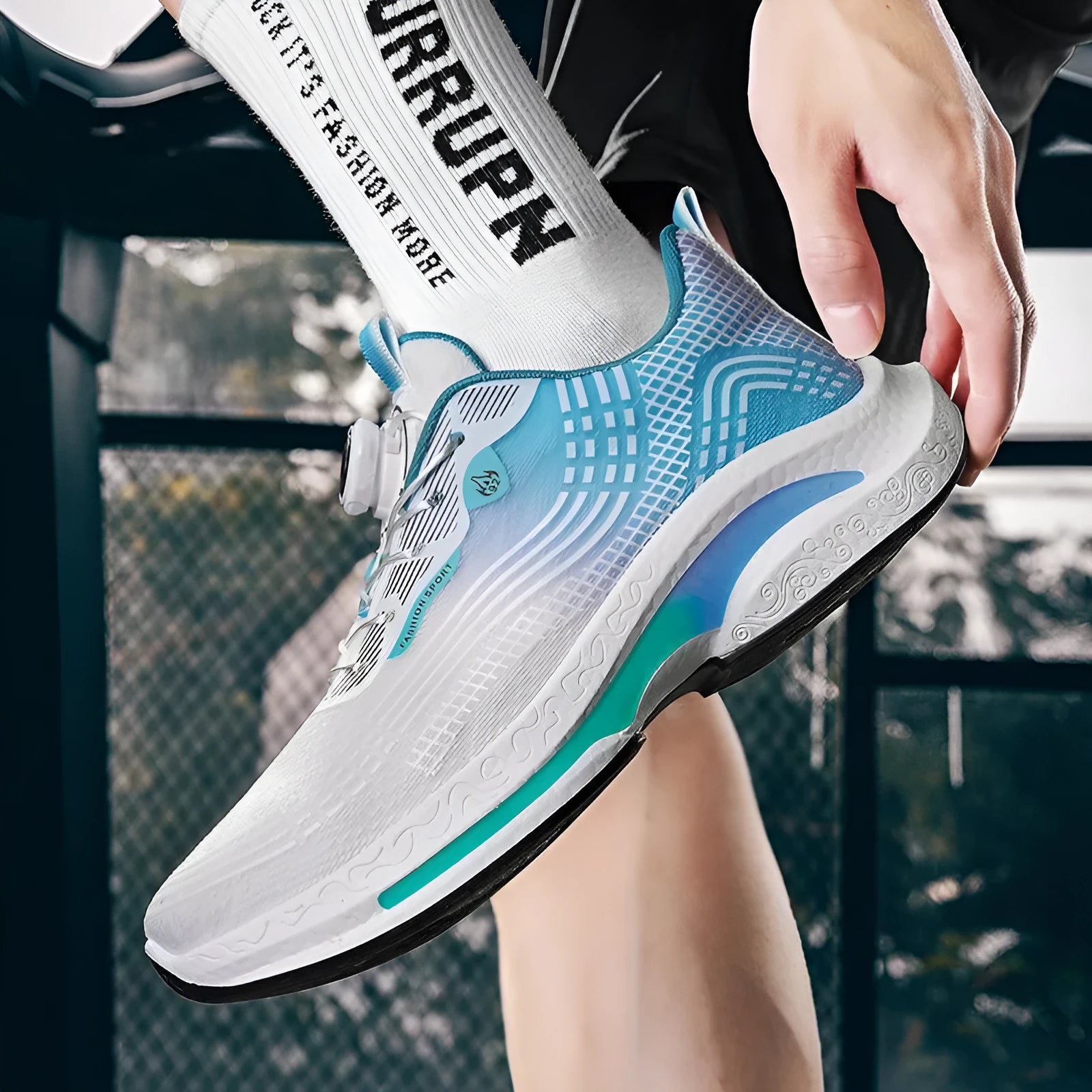Men's low-top sneaker in black and blue with a rotating buckle and mesh lining.