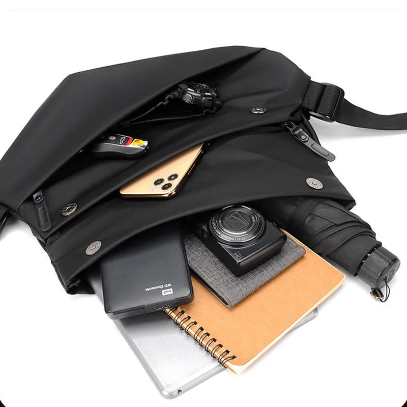 A medium-sized grey crossbody bag for men made from PU leather with a single shoulder strap.